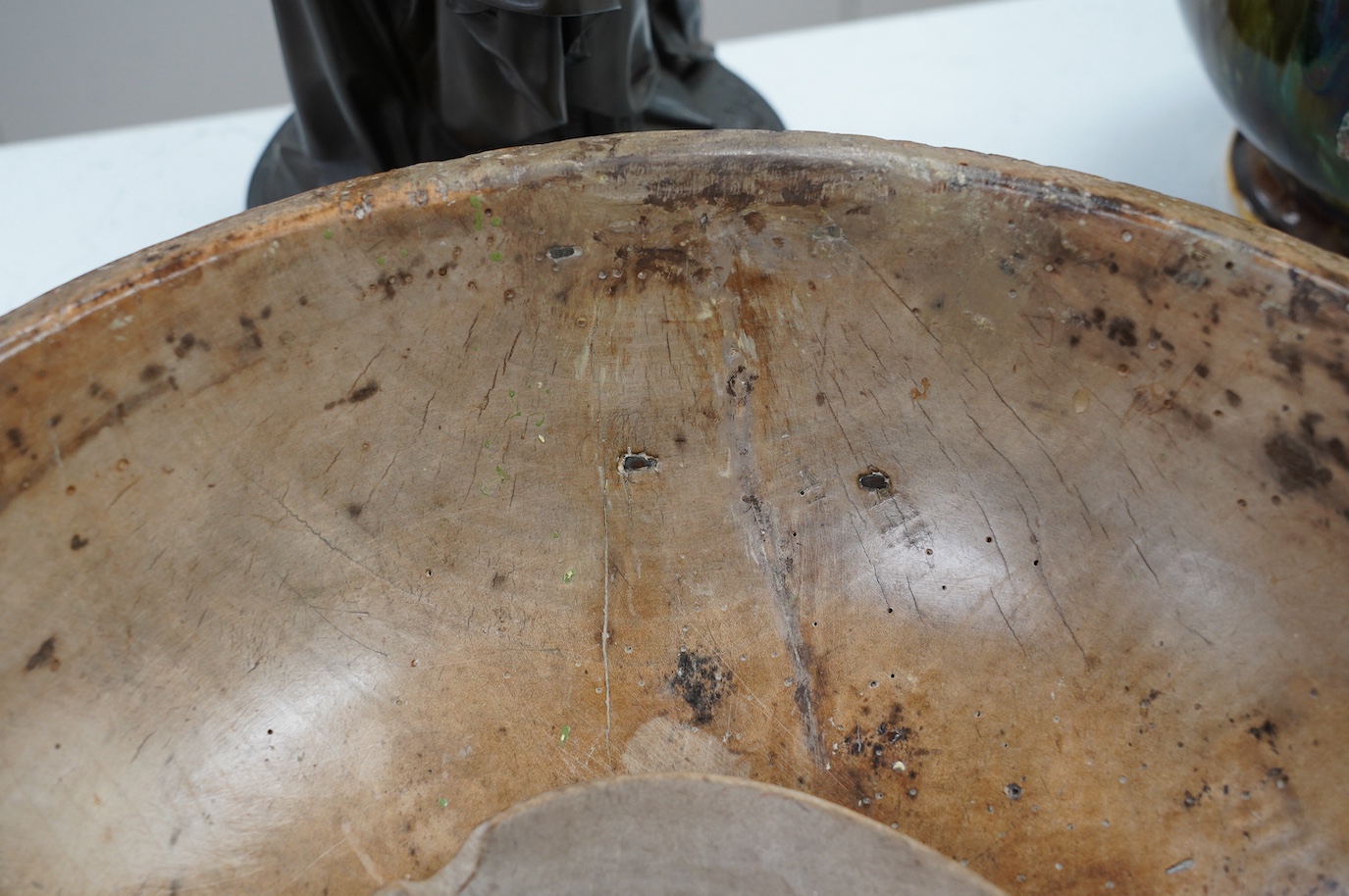 An 18th/19th century sycamore mixing bowl and a smaller bowl, largest 44cm diameter. Condition - poor